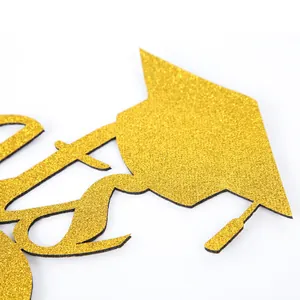 Macro view of gold glitter graduation cap wall sticker for 2026 party background decoration