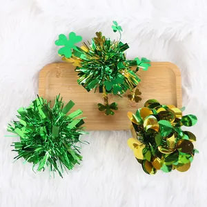 Detailed view of St. Patrick's Day hair clips featuring green tinsel and shamrock decorations.