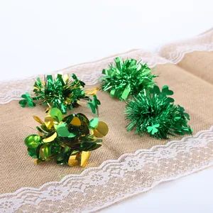 Detailed view of St. Patrick's Day green tinsel hair clips with shamrock motifs