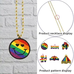 Detailed close-up of Rainbow Pride necklace with vibrant heart and PRIDE letter pendants
