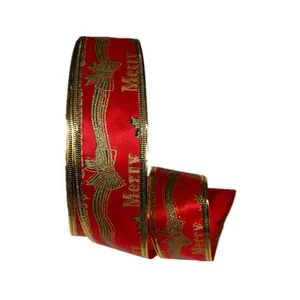 Close-up of red Christmas ribbon with gold Merry print and bow patterns