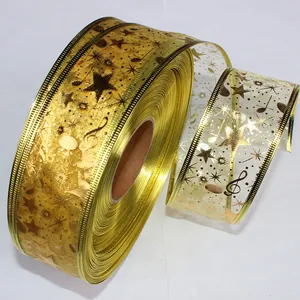 Detailweergave van 5 cm breed gouden kerstlint met patronen van muzieknoten en sterren