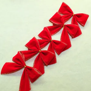 Close-up of red velvet Christmas ribbon bows with gold edges for tree decoration