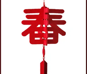 Close-up of a 3D red felt 'Chun' character pendant for Chinese New Year decoration