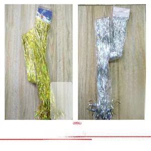 Close-up of gold and silver metallic tinsel fringe curtains for party background decor