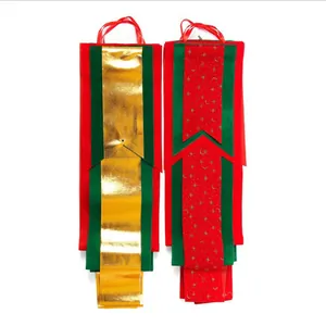 Detail view of festive red green and gold Christmas hanging ribbon banners