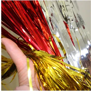 Detailed macro view of red gold and silver foil fringe curtains for party background decor