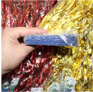 Detail view showing a stack of metallic red and gold tinsel foil fringe curtains for party
