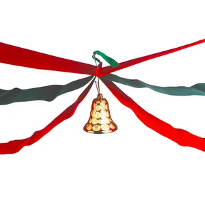 Close-up of a festive golden Christmas bell with red and green ribbon ceiling streamers for parties