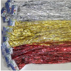 Detailed view of silver gold and red foil fringe curtains for party background decor