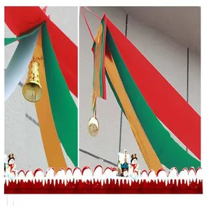 Detailed view of colorful Christmas hanging ribbons with golden bells and snowman trim