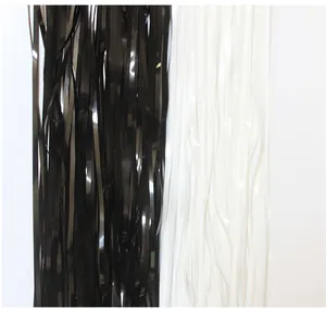 Close-up detail showing the texture of black and white shiny tinsel fringe curtains for parties