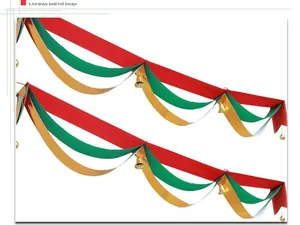 Detail of 3.3m festive Christmas wave garland in red, green, and gold with gold bells.