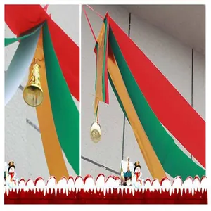 Detailed view of red green and gold Christmas streamers for ceiling decoration