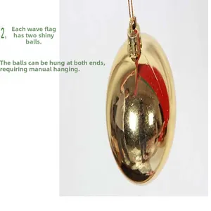 Close-up of gold Christmas ornament ball with hanging string for holiday decor.