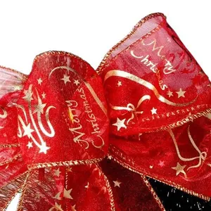Festive red sheer Christmas bow featuring gold glittery Merry Christmas text and star patterns