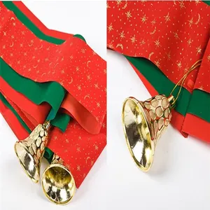 Close-up shot of red and green Christmas ribbons with star patterns and gold bells