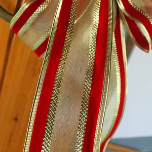 Elegant large red and gold velvet Christmas bow ornament for holiday tree decoration.