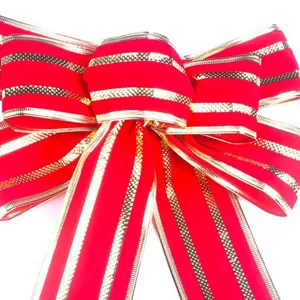 Large red velvet Christmas bow with shimmering gold glitter edges for festive home decor