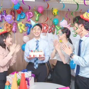 Colorful metallic spiral ceiling streamers hanging at a cheerful birthday party scene.