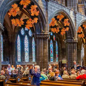 Halloween decorative wreath featuring maple leaves and bats in a cathedral setting