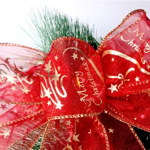 Festive large red Merry Christmas bow with gold stars for Christmas tree ornament