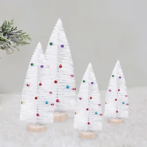 Frosted white mini Christmas tree set decorated with colorful bells and wooden bases