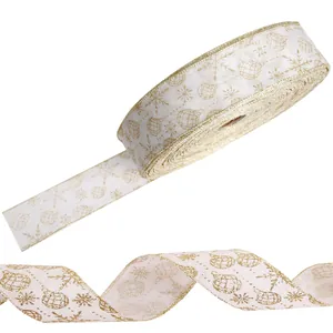 Decorative Christmas ribbon featuring gold glitter snowflakes and baubles on white fabric