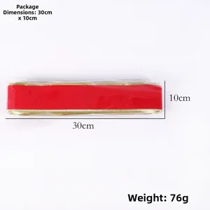 Detail of red velvet ribbon roll with gold edges, showing 10x30cm size and 76g weight.