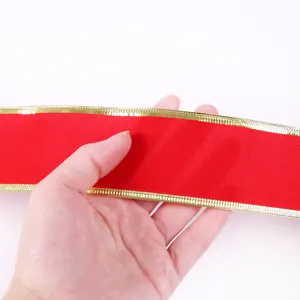 Detail showing texture of red velvet ribbon with metallic gold edge for Christmas