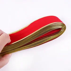 Detail of 10m red velvet ribbon with metallic gold wired edge for Christmas tree decoration