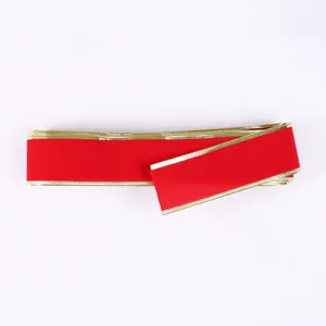 Close-up of luxurious red velvet ribbon featuring elegant gold metallic wire edges