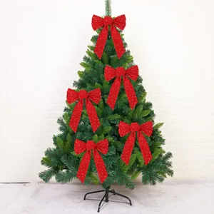 Large red velvet Christmas tree bows with elegant gold star moon glitter decorations