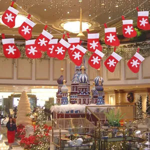 Festive red felt Christmas stocking garland with snowflake patterns for party decor