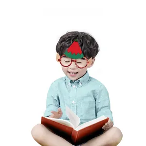 Detail shot of a child wearing funny glittery Christmas glasses with an elf hat and ears.