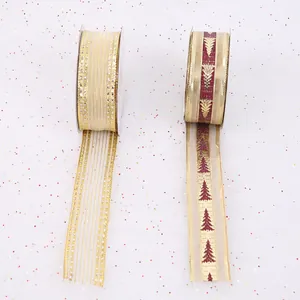 Detail of gold striped and Christmas tree patterned wired ribbons for gift wrapping