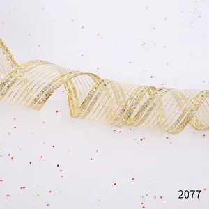 Macro view of gold and silver wire-edged Christmas ribbon with glitter stripe pattern