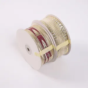 Detail view of two rolls of Christmas wire-edged ribbons with tree and glitter patterns