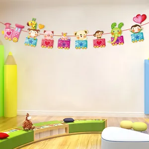 Detailed view of a colorful cartoon animal train party banner hanging in a bright nursery room