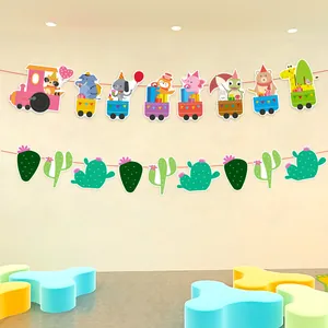 Colorful cartoon animal train and cactus party banner hanging in a decorated kids room