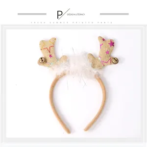 Close-up detail of festive glitter reindeer antler headband featuring white faux fur and bells