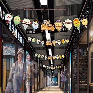 Cartoon Halloween ghost and pumpkin hanging banner decorations in a shopping mall corridor