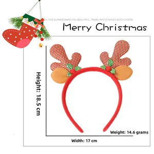Detailed view of a festive red reindeer antler headband with holly leaf and berry accents
