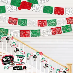 Detail view of Mexican party papel picado banners and garlands on a staircase railing.
