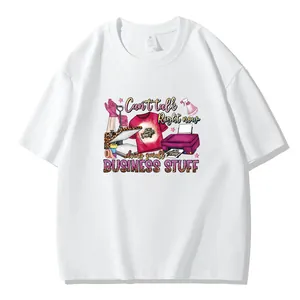 Close-up of DIY heat transfer decal with 'Business Stuff' text on white t-shirt