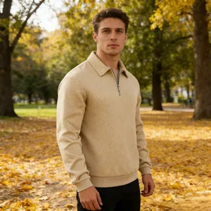 Detailed view of men's beige textured jacquard quarter-zip polo sweatshirt in autumn park