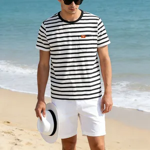 Detail view of men's casual black and white striped T-shirt with pocket in beach setting