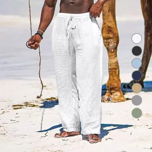 Breathable white cotton linen wide-leg pants for men shown in a sunny beach setting