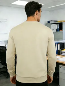 Vista posteriore dettagliata di una felpa beige da uomo in un ambiente d'ufficio.