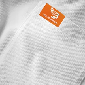 Close-up detail of the pocket with an orange woven label on a premium white cotton T-shirt